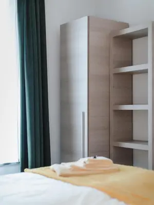 a bedroom with a bed with a wooden closet at Apartment The City in Ghent
