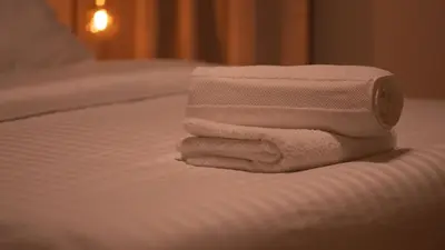 a pile of towels sitting on top of a bed at LUXURY LUMINOUS 2bedroom apt CENTER of BRUSSELS in Brussels