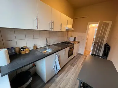a kitchen with a sink and a counter top at Cosy Apartment Merode in Brussels