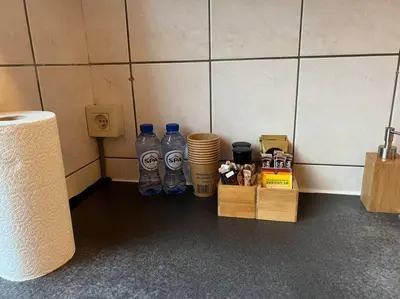 two bottles of water sitting on the floor in a room at Cosy Apartment Merode in Brussels