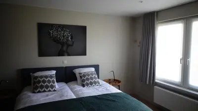 a bedroom with a bed with two pillows on it at B&B Maaltebrug in Ghent