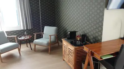 a room with two chairs and a table and a desk at B&B Maaltebrug in Ghent