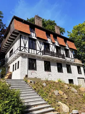 a large building with stairs in front of it at La Garçonnière Genval in Rixensart