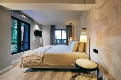 a bedroom with a large bed and a window at La Garçonnière Genval in Rixensart