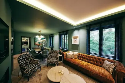 a living room with a couch and a table at La Garçonnière Genval in Rixensart
