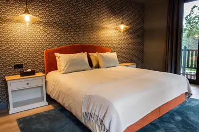 a bedroom with a large bed and a window at La Garçonnière Genval in Rixensart