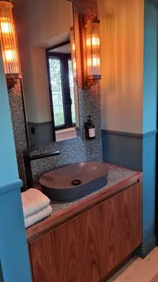 a bathroom with a sink and a mirror at La Garçonnière Genval in Rixensart
