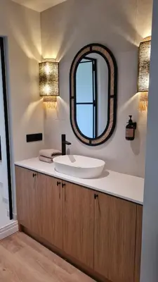 a bathroom with a sink and a mirror at La Garçonnière Genval in Rixensart
