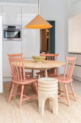 a kitchen with a wooden table with chairs and a lamp at SHWAY - The Saffron Dress in Antwerp