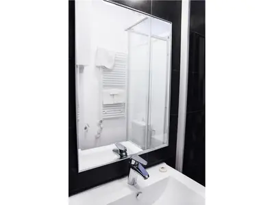 a bathroom with a sink and a large mirror at Hotel Satellite in Brussels