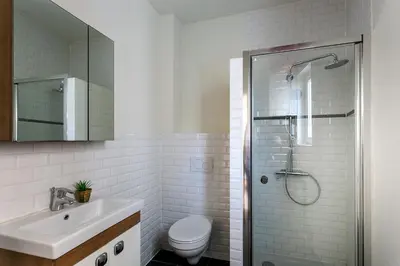 a bathroom with a shower and a sink and a toilet at Nice furnished appartement AAA- location in Antwerp