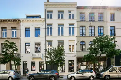 a large white building with cars parked in front of it at Nice furnished appartement AAA- location in Antwerp