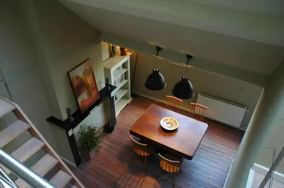 an overhead view of a dining room with a table and chairs at Villa des Roses Voltaire in Brussels