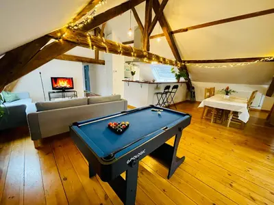a living room with a pool table and a couch at Charming Loft in Prime Location in Brussels
