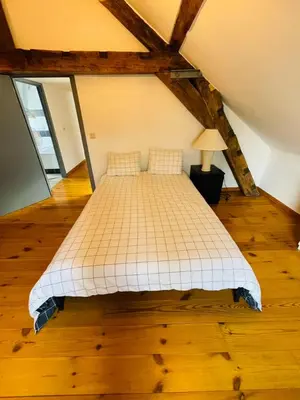 a bedroom with a white bed in a attic at Charming Loft in Prime Location in Brussels