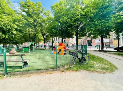 a bike parked next to a playground in a park at Charming Loft in Prime Location in Brussels