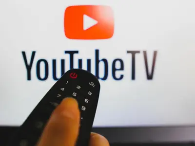 a person holding a remote control in front of a youtube tv at Charming Loft in Prime Location in Brussels
