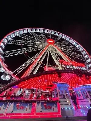 a ferris wheel at night with red lights at Charming Loft in Prime Location in Brussels