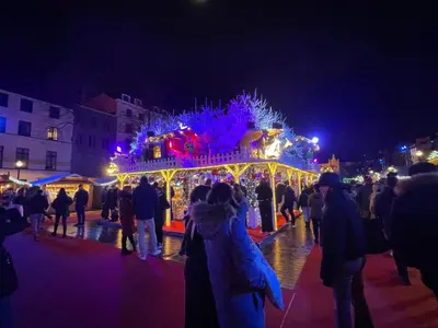 a group of people standing around a christmas carousel at Charming Loft in Prime Location in Brussels