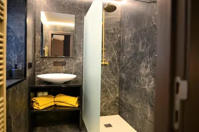 a bathroom with a sink and a mirror at Modern apartment with terrace at Theaterplein in Antwerp