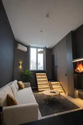 a living room with a couch and a fireplace at Modern apartment with terrace at Theaterplein in Antwerp