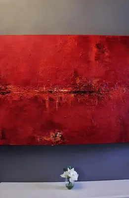 a red painting on a wall with a vase of flowers at B&B Avenue Deschanel in Brussels