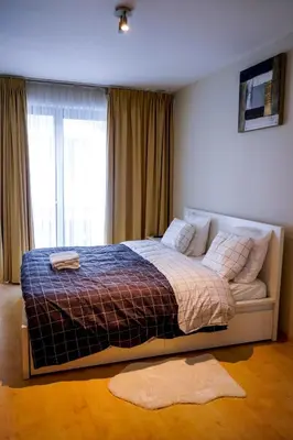 a bedroom with a bed with a large window at Garden Botanique Apartment in Brussels
