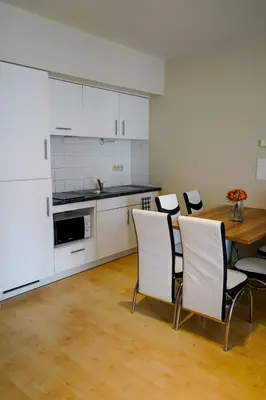 a kitchen and dining room with a table and chairs at Garden Botanique Apartment in Brussels