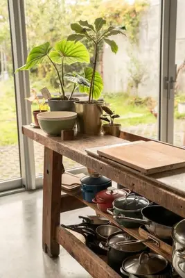 a kitchen counter with pots and pans on a table at Mari's: Multifunctional Shelter with big Garden in Ghent