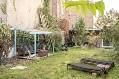 a gazebo with two benches in a yard at Mari's: Multifunctional Shelter with big Garden in Ghent