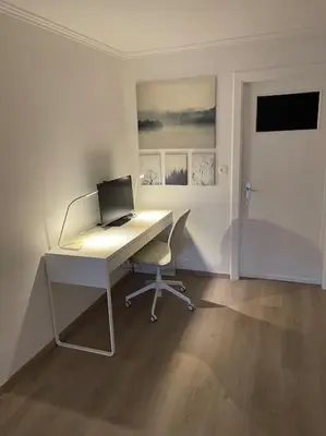an office with a desk with a laptop computer on it at Cosy flat for 4 p. with garden in Tremelo in Tremelo