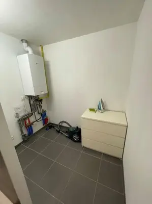 a room with a white cabinet and a tiled floor at Cosy flat for 4 p. with garden in Tremelo in Tremelo