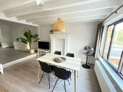 a dining room with a table and chairs at Cosy flat for 4 p. with garden in Tremelo in Tremelo