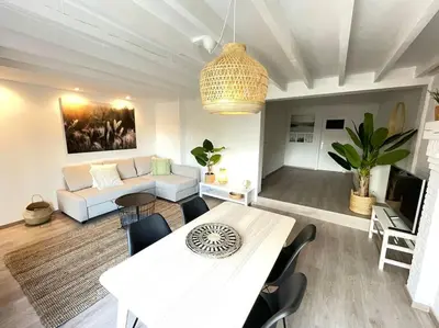 a living room with a table and a couch at Cosy flat for 4 p. with garden in Tremelo in Tremelo