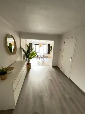 an empty living room with a table and a mirror at Cosy flat for 4 p. with garden in Tremelo in Tremelo