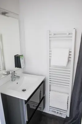 a bathroom with a sink and a mirror at TravelEase - Midi in Brussels
