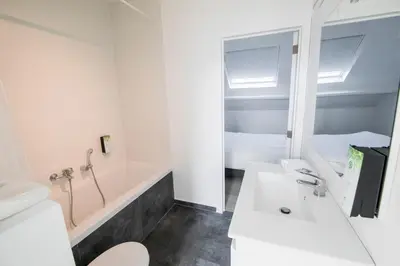 a bathroom with a tub and a sink and a toilet at TravelEase - Midi in Brussels