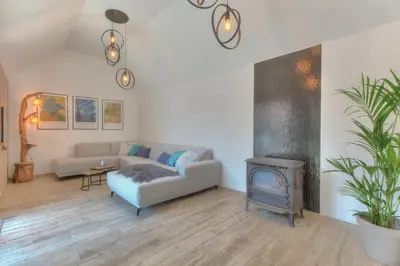 a living room with a couch and a fireplace at Cap d'Eau in Waasmunster