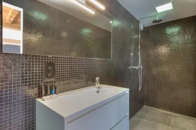 a bathroom with a white sink and a shower at Cap d'Eau in Waasmunster