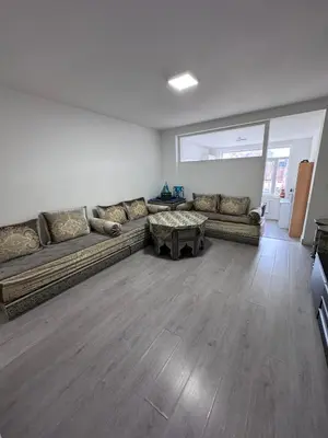 a living room with two couches and a table at Appartement Deux chambres près de Atomium in Brussels