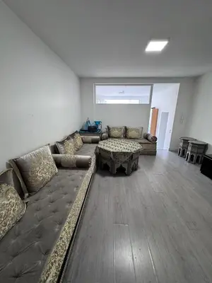 a living room with a couch and a table at Appartement Deux chambres près de Atomium in Brussels