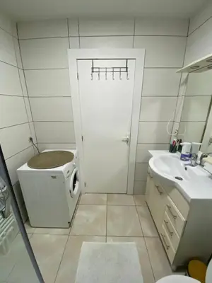 a bathroom with a toilet and a sink and a door at Appartement Deux chambres près de Atomium in Brussels