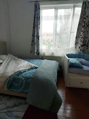 a bedroom with a bed and a window with curtains at Belle chambre dans un quartier calme in Brussels