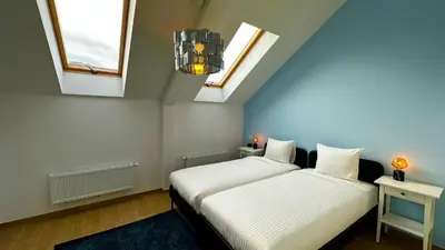 two beds in a room with two windows at OneLuxStay near Fashion District in Antwerp