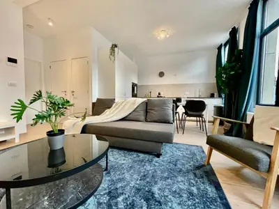 a living room with a couch and a table at OneLuxStay near Fashion District in Antwerp