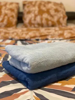 a pile of towels sitting on top of a bed at Campe-good in Kampenhout