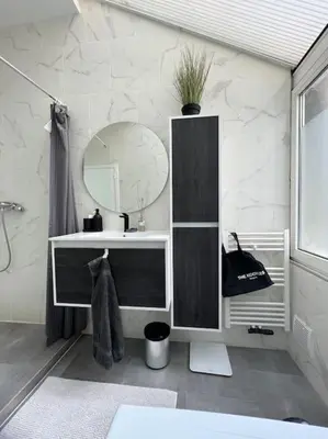 a bathroom with a sink and a mirror at L Escapade Urbaine in Brussels