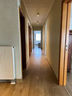 an empty hallway of an apartment with wooden floors at Appartement29 in Wetteren