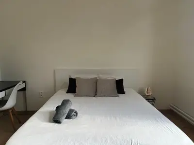 a bedroom with a large white bed with two pillows at Lily Flower - B&B in Kapelle-op-den-Bos