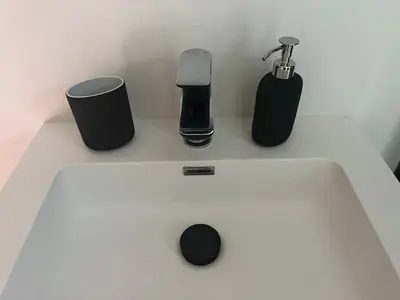a white sink with three items on top of it at Lily Flower - B&B in Kapelle-op-den-Bos